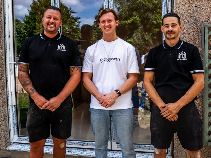 Callum with the owners of JBC Windows outside a job